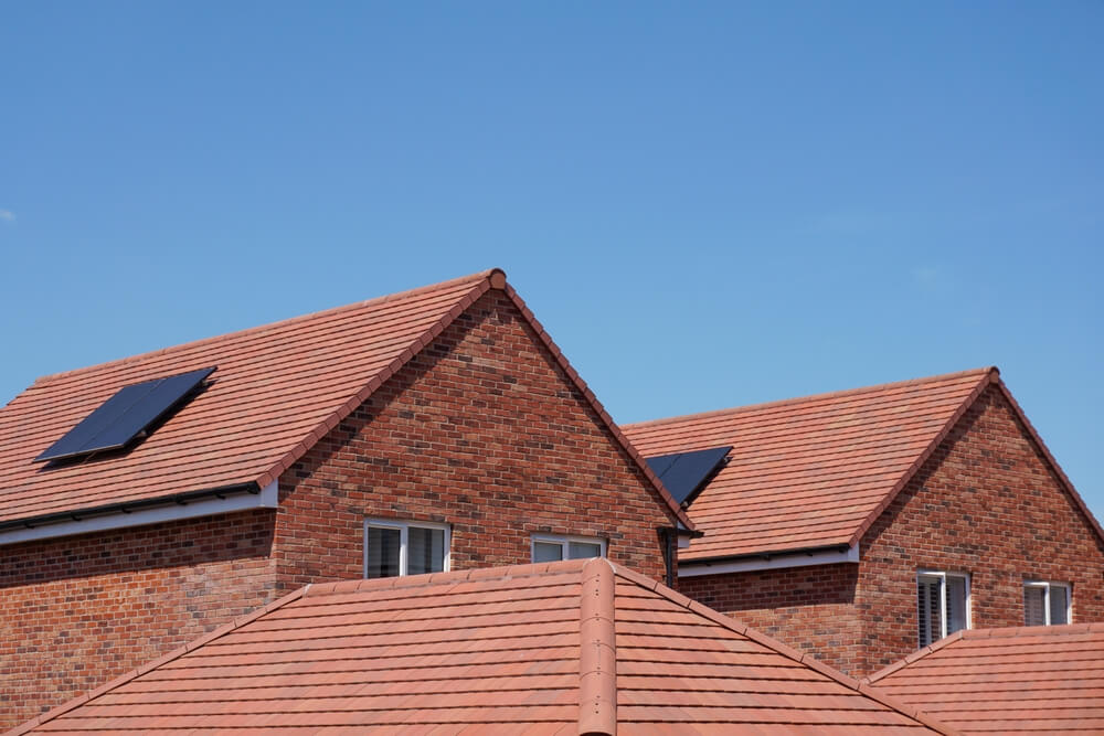 A series of roofs of red brick built houses